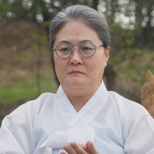 aunt character appearing in traditional outfit.